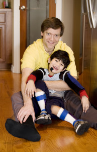 little boy with disabilities and father
